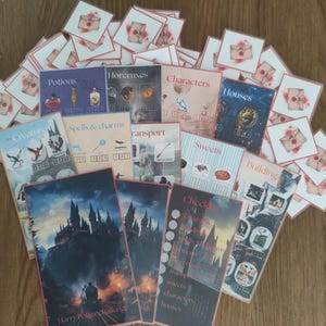 May include: A selection of illustrated cards and booklets, with titles such as "Potions," "Horcruxes," and "Characters." The cards and booklets are arranged on a wooden surface. Some cards feature a watercolor envelope design.