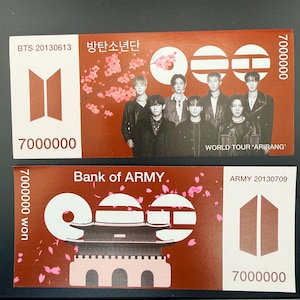May include: Two rectangular paper tickets featuring BTS branding. The top ticket shows seven individuals, cherry blossoms, and the text 'BTS 20130613', '7000000', and 'WORLD TOUR ARIRANG'. The bottom ticket displays 'Bank of ARMY', '7000000 won', and 'ARMY 20130709'.