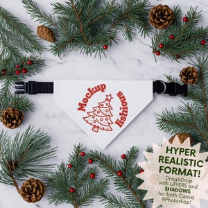May include: A white pet bandana with a red Christmas tree design and the text "Mockup lishious". The bandana has a black adjustable collar. The image is surrounded by pine branches, pine cones, and red berries.