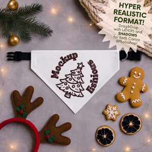 May include: A white dog bandana with a Christmas tree design and the words "Mockup Fishious" in a circular pattern. The image includes a gingerbread man, reindeer antlers, and decorative elements.