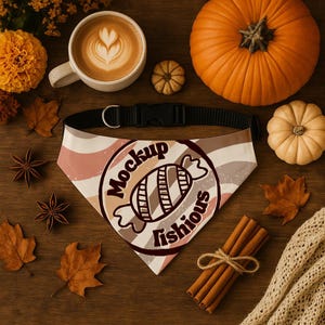 May include: A dog bandana with a black collar and a candy graphic, with the text "Mockup Fishious". The bandana has a beige, brown, and pink wavy pattern. The image also includes pumpkins, coffee, and fall foliage.