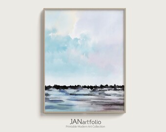 May include: Framed abstract landscape art print. The artwork features a watercolor style with a sky of light blue and lavender hues. Below, a dark line suggests a horizon, with reflections in the water. The text "JANartfolio" is at the bottom.