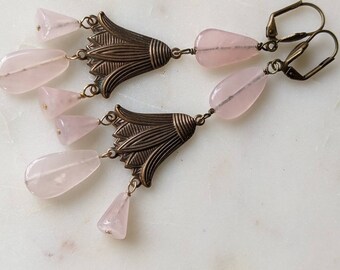 rose quartz earrings with an art deco / Egyptian revival vibe. antique style brass tulip embellishments with rose quartz cones and teardrops