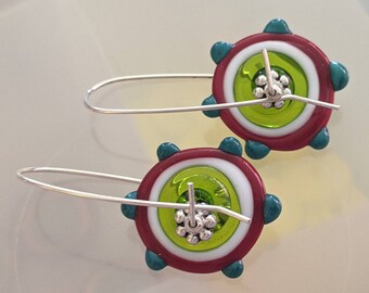 red, white, translucent green and teal handmade lampwork pinwheels on sterling silver wires