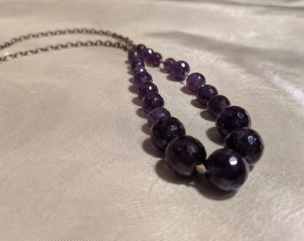 amethyst faceted beads hand knotted with antique brass chain 24" long, adjustable.