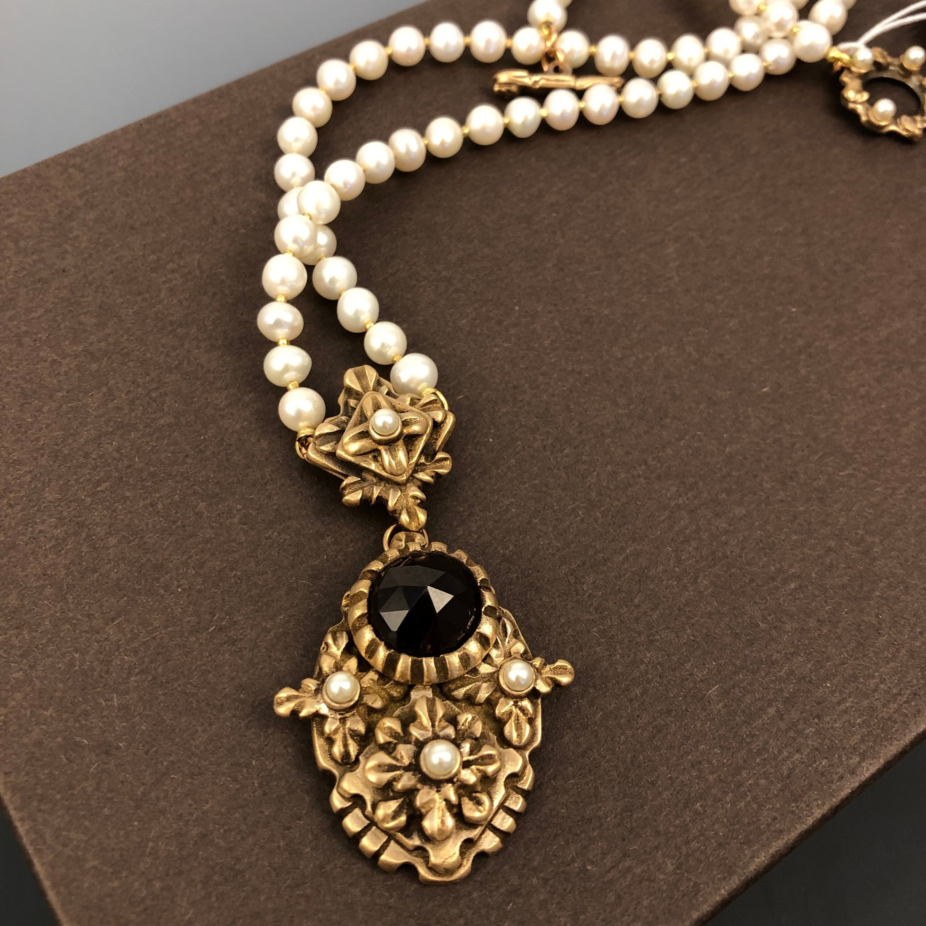 Historically inspired hand carved bronze pendant necklace with