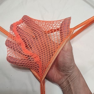 May include: Orange fishnet lingerie with a thin orange ribbon trim.