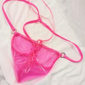 May include: A white ceramic mug with a black handle and the text "But First, Coffee" in a black, bold font. The mug is on a white surface.