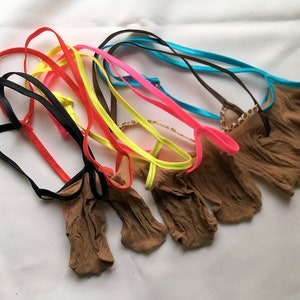 Op de afbeelding: Een set van acht kleurrijke lingerie-bandjes met bruine gaasjes. De bandjes zijn gemaakt van verschillende materialen, waaronder satijn, nylon en elastiek.