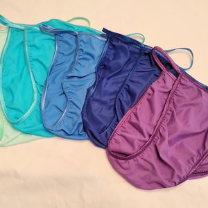 May include: Five pairs of silky, smooth, and stretchy underwear in a rainbow of colors, including light green, turquoise, blue, navy, and purple.