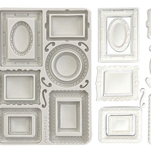 May include: A silicone mold featuring various frame designs in different shapes and sizes. The frames include rectangular, oval, and circular shapes, with ornate detailing. The mold is light gray, and the frames are white.