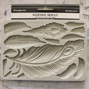 May include: Silicone mold for crafting with a design of multiple peacock feathers. The mold is 14.8 inches by 21 inches.