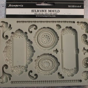 May include: Silicone mold with intricate designs, including frames, circles, and flourishes. The mold is 14.8 inches by 21 inches.