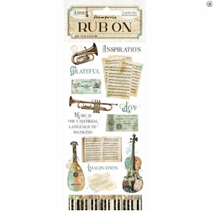 Op de afbeelding: Een vel wrijf-op transfers met een muzikaal thema. Het vel bevat afbeeldingen van muziekinstrumenten zoals een trompet, viool en mandoline, samen met muzieknoten en de woorden "Music is the universal language of mankind". Het vel meet 10,16 x 21,6 cm.