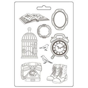 May include: A black and white line drawing of a set of nine different images, including a book, a birdcage, a clock, a pair of boots, a telephone, and a bird. The images are arranged in a grid pattern on a white background.