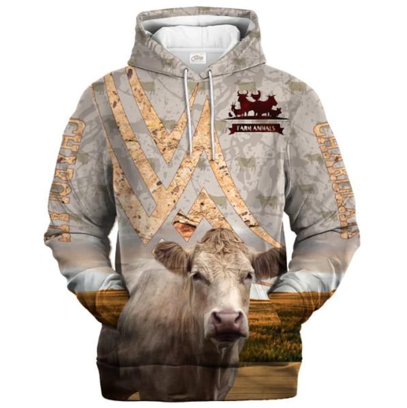May include: A beige hooded sweatshirt featuring a large, realistic cow graphic on the front, a field landscape, and a textured pattern of cattle silhouettes. The text "FARM ANIMALS" and "CHAROLAIS" are printed on the garment in a dark brown font.
