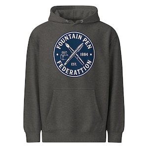 May include: Dark gray hoodie with a front pocket and a drawstring hood. The front features a navy blue circular graphic with the words "FOUNTAIN PEN FEDERATION" and the year "1884". The graphic includes crossed pens and an ink bottle.