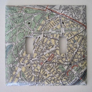 May include: A light switch cover featuring a vintage map of Paris, France. The map includes street names like Avenue de la Division, Avenue de Malakoff, and Avenue Foch.