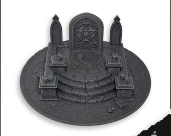 May include: A dark gray miniature altar with a pentagram design on the back. The altar has a circular base with steps leading up to a raised platform. Two small pillars flank the back, and two more are on the front corners. The Keep Design logo is in the bottom right corner.