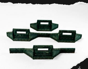 May include: Three dark green miniature defense line models with rectangular openings. The text "DEFENCE LINE" is at the top of the image. The models are designed for tabletop gaming and are made of a textured material.