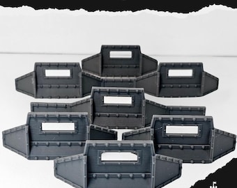 May include: A collection of gray, modular defense shields with rectangular viewing windows and rivet detailing. The text "DEFENCE LINE" is displayed at the top. The shields are arranged in a semi-circular pattern.