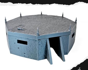 May include: A gray, octagonal bunker model with a textured roof and small spires. The bunker has a rectangular opening and a ramp leading to the entrance. The word "BUNKER" is printed at the top.