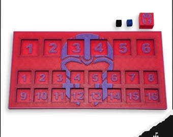May include: A red game board with numbered squares and a purple emblem. Includes three dice, two small and one larger, all with the same emblem. The numbers 1-16 are visible on the board. The Keep Design logo is in the bottom right corner.