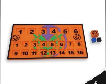 May include: An orange Halloween-themed game board with numbered squares and a central design. Includes three dice, one orange with a jack-o'-lantern face, and two smaller dice in blue and black. The board has the numbers 1-16.