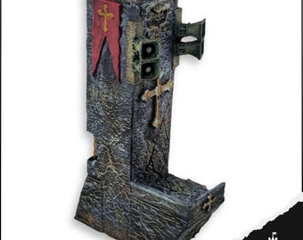 May include: A weathered, stone-like sculpture with a cross and red banner. The sculpture has a rectangular shape with a detailed, textured surface. Additional features include a gold cross and speaker-like elements.