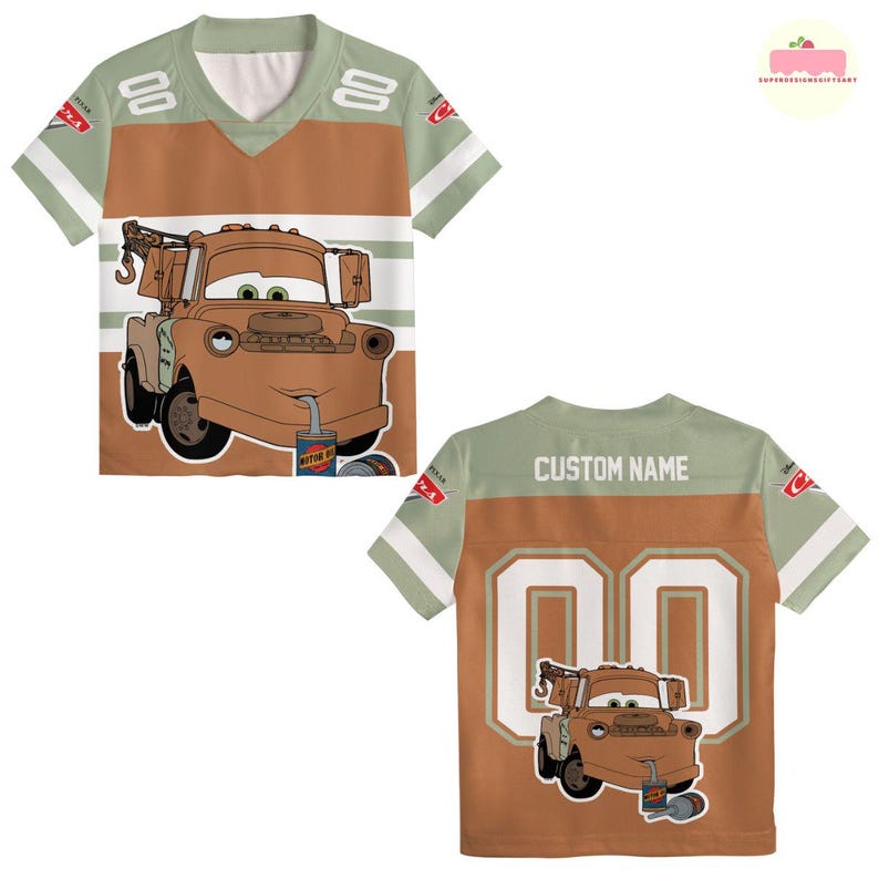 May include: A brown and green jersey-style t-shirt featuring a cartoon image of Tow Mater from the movie Cars. The front of the shirt has the character's image, while the back has the number "00" and space for a custom name.