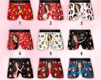 May include: Nine pairs of boxer briefs with various designs. The designs include images of a woman's face, bananas, hearts, and lips. Some pairs have text that reads "ONLY IONA" and "Ticket so it's mine".