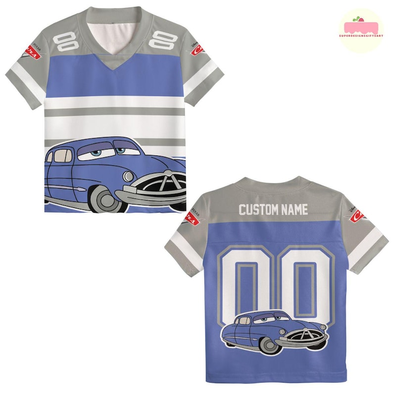 May include: A blue and gray jersey-style t-shirt featuring a cartoon car graphic. The front has a blue and white stripe design with the number "00" on the back. The shirt has short sleeves and a v-neck.