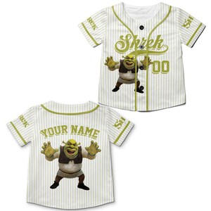 May include: White baseball jersey with green pinstripes and accents. Features a cartoon image of Shrek and the word "Shrek" in green script. The back of the jersey has the words "YOUR NAME" in green.