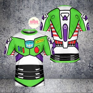 May include: A green, white, and purple t-shirt featuring a design inspired by the character Buzz Lightyear. The front of the shirt displays the Space Ranger badge and the word "Lightyear". The back of the shirt has a power button graphic.