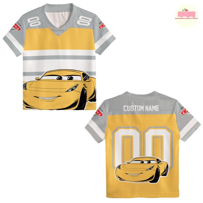 May include: Yellow and gray jersey-style t-shirt featuring a cartoon car graphic. The front of the shirt has a large car graphic and the number "00" on the sleeves. The back of the shirt has the text "CUSTOM NAME" and another car graphic.