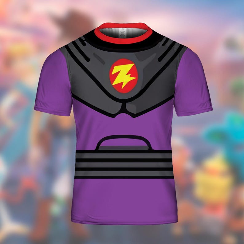 May include: Purple t-shirt with a black and gray design, featuring a yellow lightning bolt emblem. The shirt has a red and black collar. The design resembles a superhero costume.