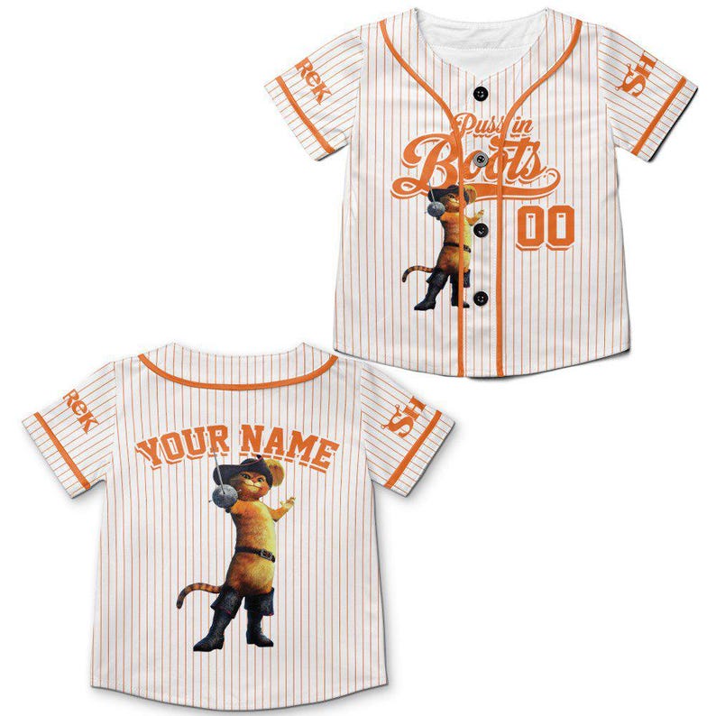 May include: White baseball jersey with orange pinstripes and trim. Features the text "Puss in Boots" and a cartoon image of the character. The jersey also has the number "00" and the text "Your Name" on the back.