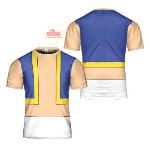 May include: A short-sleeved t-shirt featuring a design with a tan torso, blue upper section, and white lower section. The design includes yellow and blue accents. The shirt is displayed from the front and back.