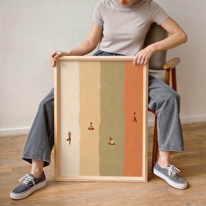 May include: A rectangular framed wall art piece featuring four vertical textured color panels in cream, yellow, sage green, and terracotta. Small figures are depicted in various yoga poses across the panels, including tree and seated positions.