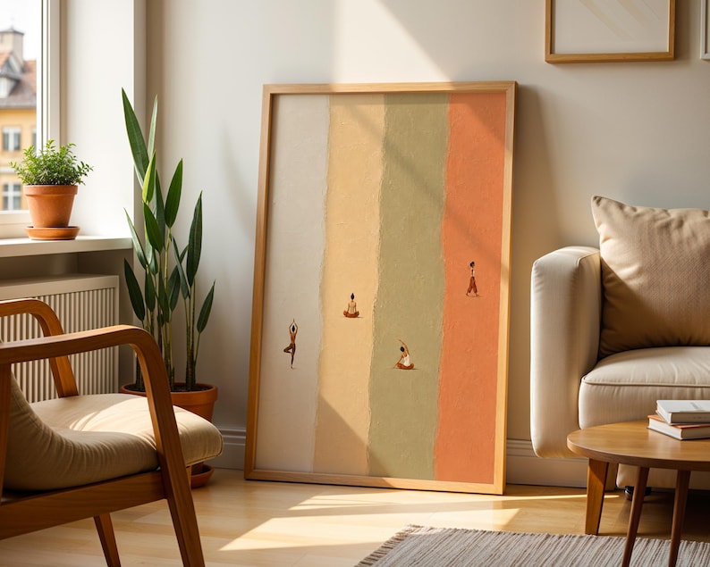 May include: A framed vertical wall art print featuring four distinct vertical color panels in cream, yellow, sage green, and terracotta. Small illustrated figures are depicted in various yoga poses and walking across the textured color blocks.