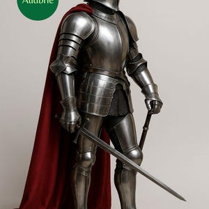 May include: A full suit of medieval armour in polished steel, including a helmet, shoulder guards, and leg protection. A red cape drapes over the shoulders. The knight holds a sword in one hand and a smaller weapon in the other.