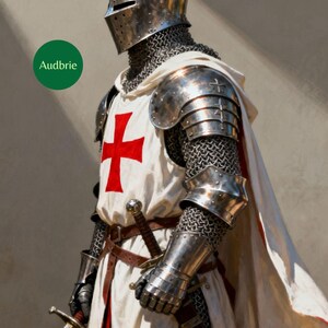 May include: A knight in shining armor, wearing a silver helmet, chainmail, and metal shoulder and arm guards. The knight's white tunic features a large red cross. A sword is held in the knight's right hand. The word "Audbrie" is in a green circle.
