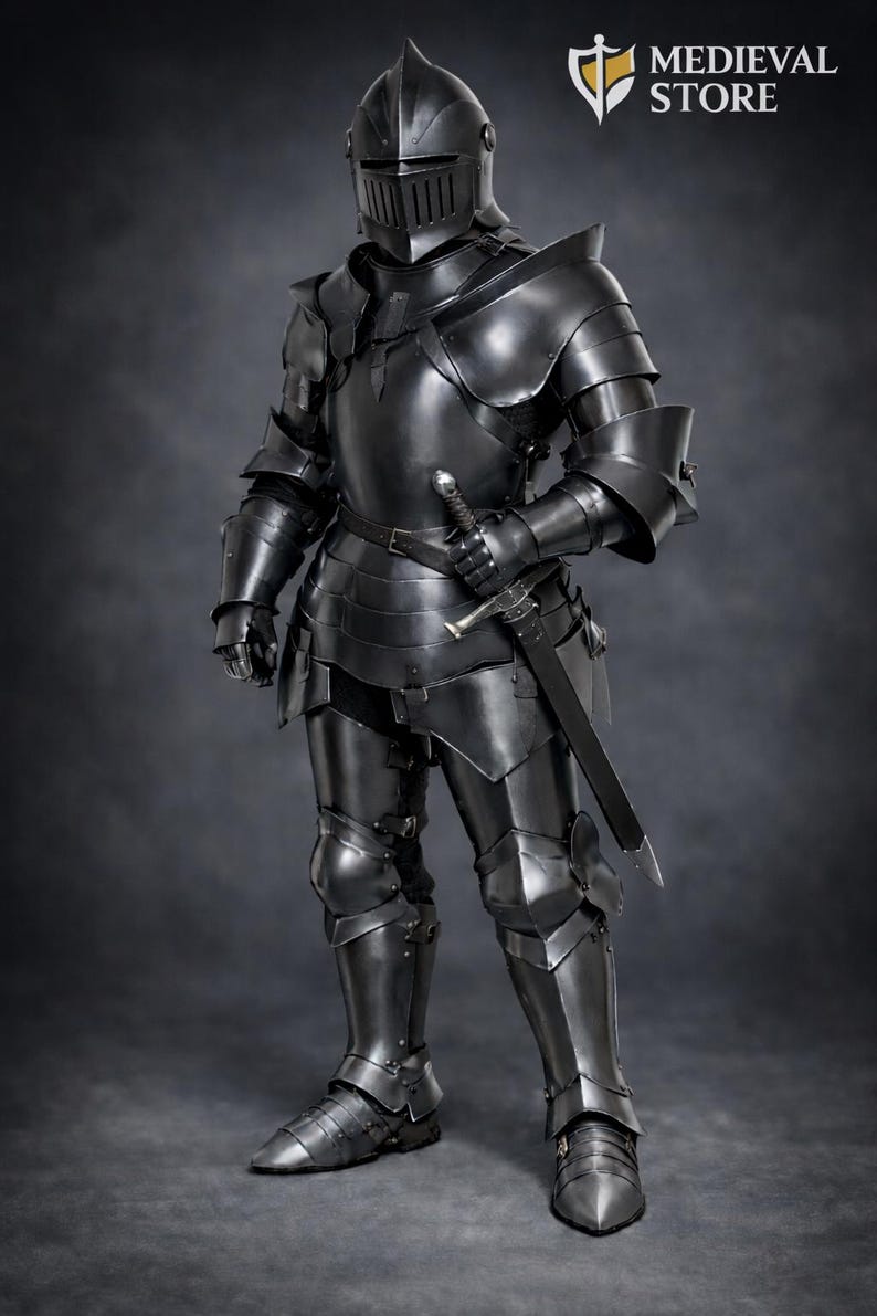 May include: Full suit of black medieval armor, including a helmet, chest plate, arm and leg protection, and a sword. The armor is highly detailed and reflective, with visible joints and rivets. The image includes the Medieval Store logo.