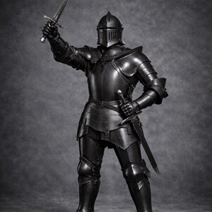 May include: A full suit of black medieval armor, including a helmet, chest plate, and leg guards. The knight is holding a sword aloft in one hand and another at their side. The Medieval Store logo is visible in the upper right corner.