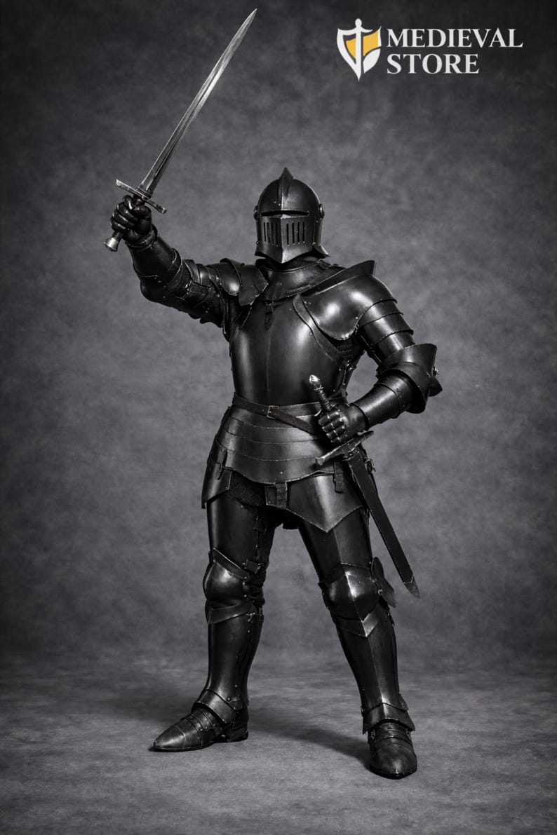 May include: A full suit of black medieval armor, including a helmet, chest plate, and leg guards. The knight is holding a sword aloft in one hand and another at their side. The Medieval Store logo is visible in the upper right corner.