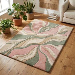 May include: A rectangular area rug featuring a tufted, abstract wave pattern in soft shades of sage green, dusty pink, and cream. The design consists of flowing, organic lines that create a layered, textured appearance across the entire surface.