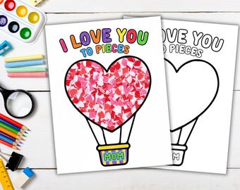 Può includere: Due biglietti di carta bianca con un disegno a forma di mongolfiera a forma di cuore. Uno è riempito di pezzi di carta rossi e rosa, l'altro è un contorno vuoto. Il testo "I LOVE YOU TO PIECES" è in alto e "MOM" è sul cestino.