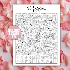 May include: Black and white "Wedding I Spy" game with various wedding-themed illustrations. Includes an answer key. The game is surrounded by pink rose petals.