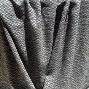 a close-up view of a crumpled gray and white patterned fabric, with a textured and wrinkled appearance.