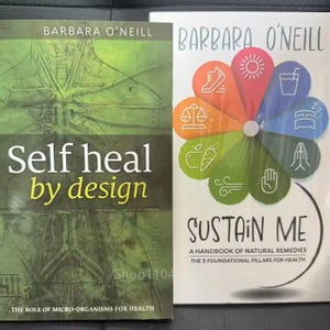 May include: Two books by Barbara O'Neill. The first book, "Self heal by design", has a green cover with white and yellow text. The second book, "Sustain Me", has a white cover with a colorful flower design and text.